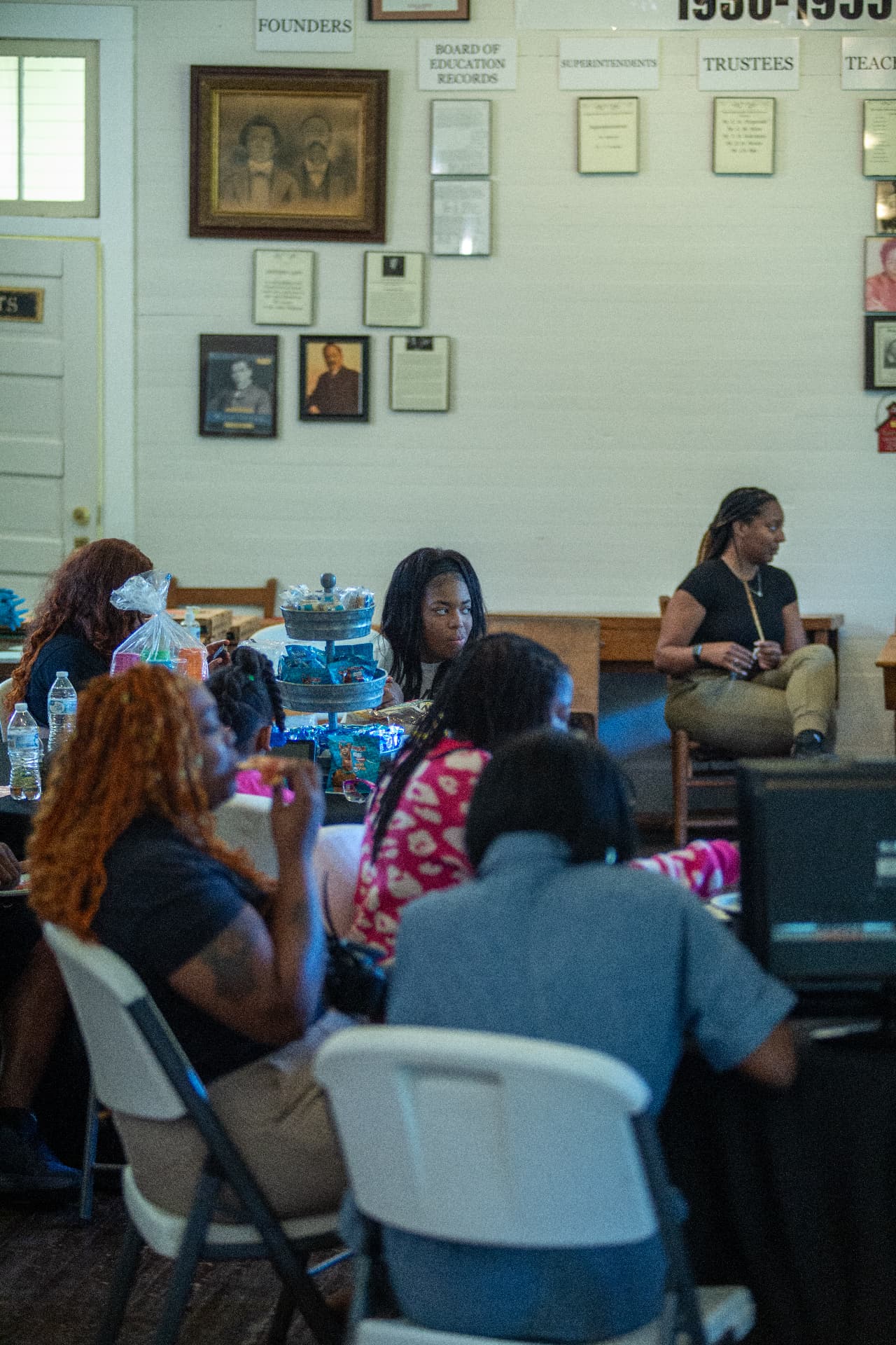 Families and students gather around tables inside the museum during STEM Day activities.