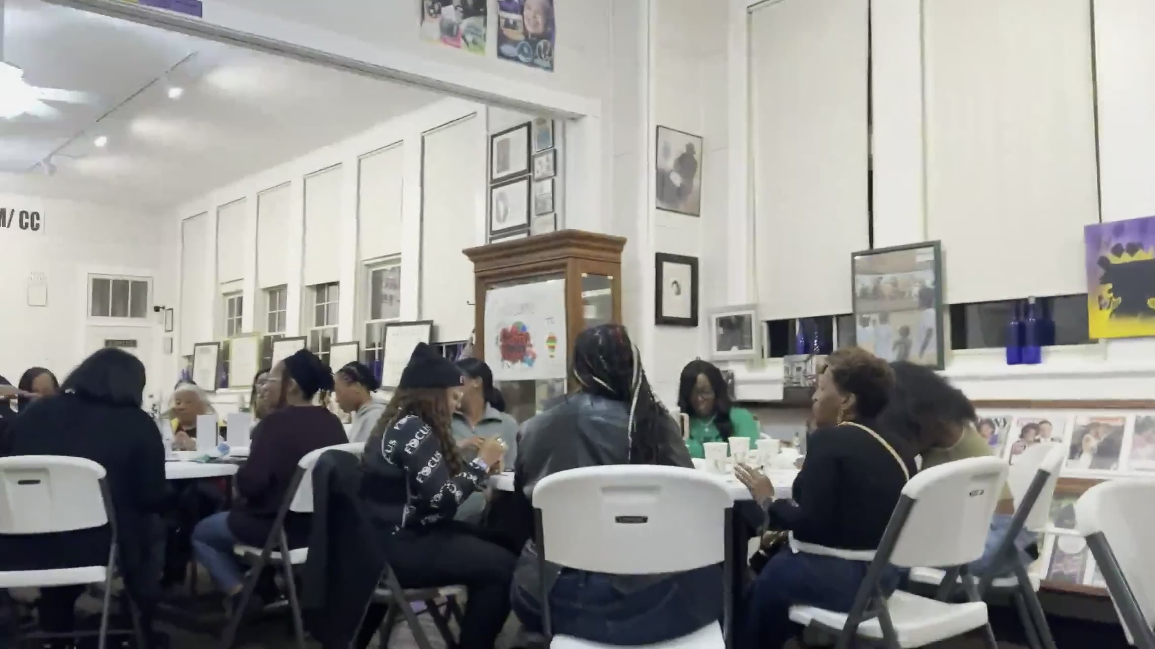 A sweeping view of guests playing bingo among the museum displays during Black History Game Night.
