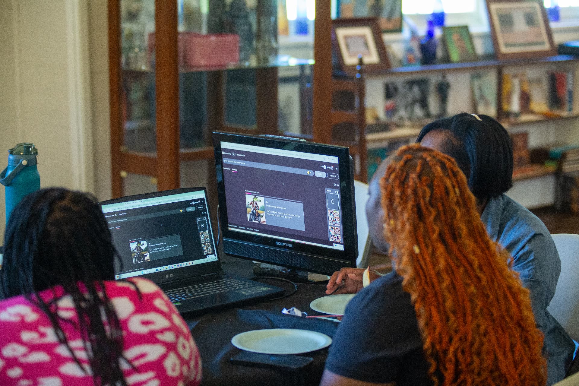 Students work together on computers in the museum gallery during STEM Day.