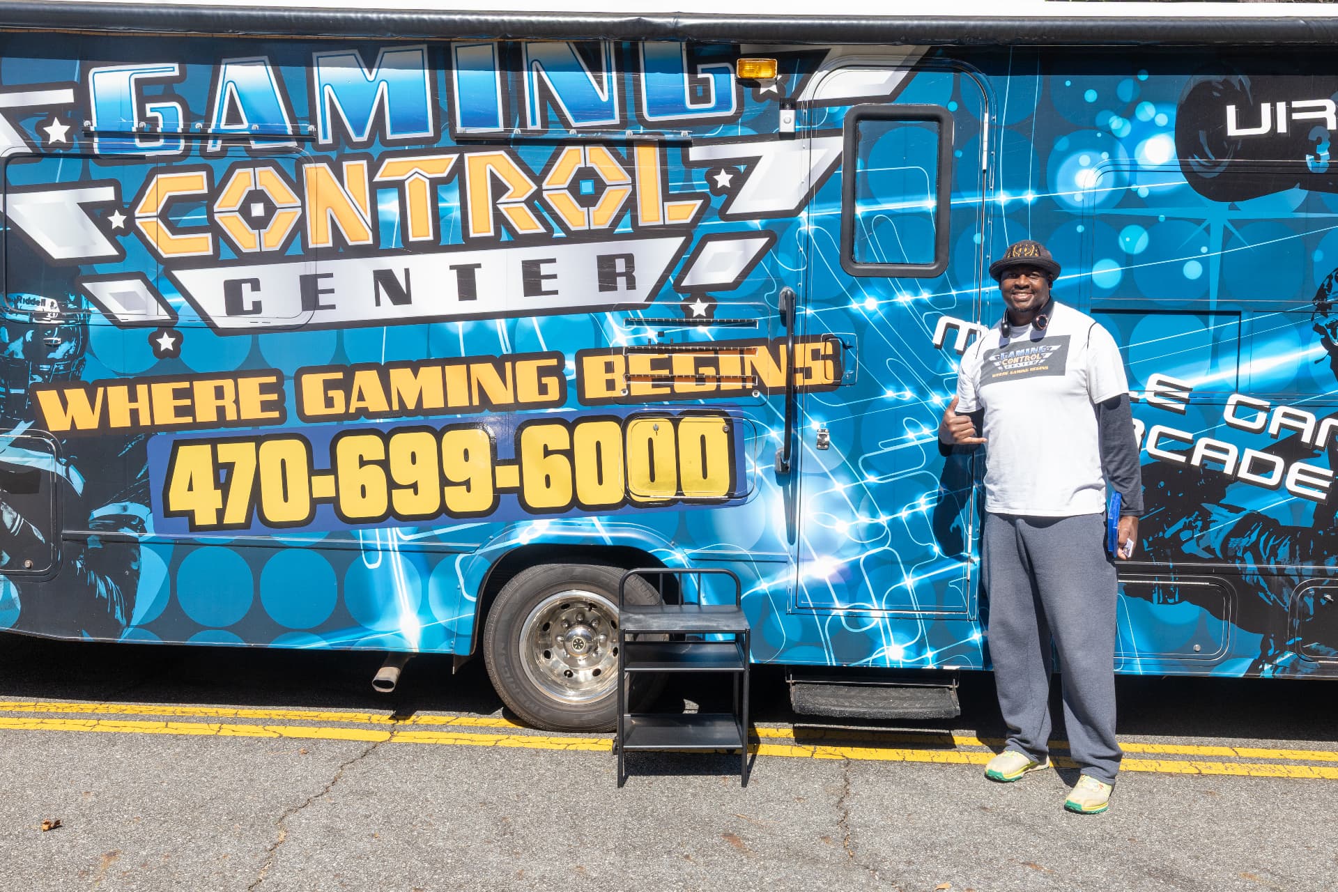 The Gaming Control Center mobile game truck parked at the block party, with its operator giving a thumbs up.