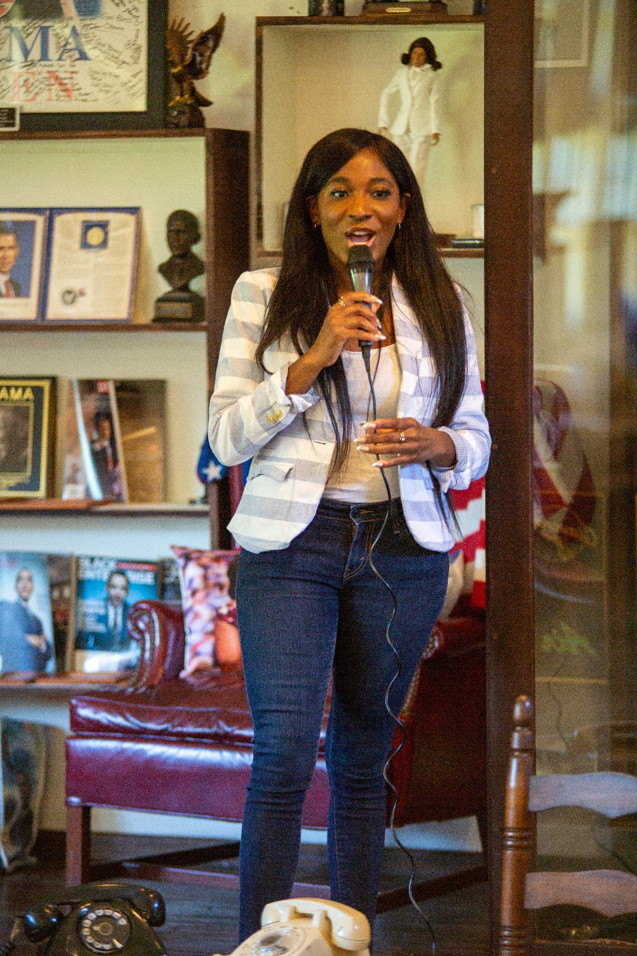 A host speaks into a microphone inside the museum during the STEM Day program.