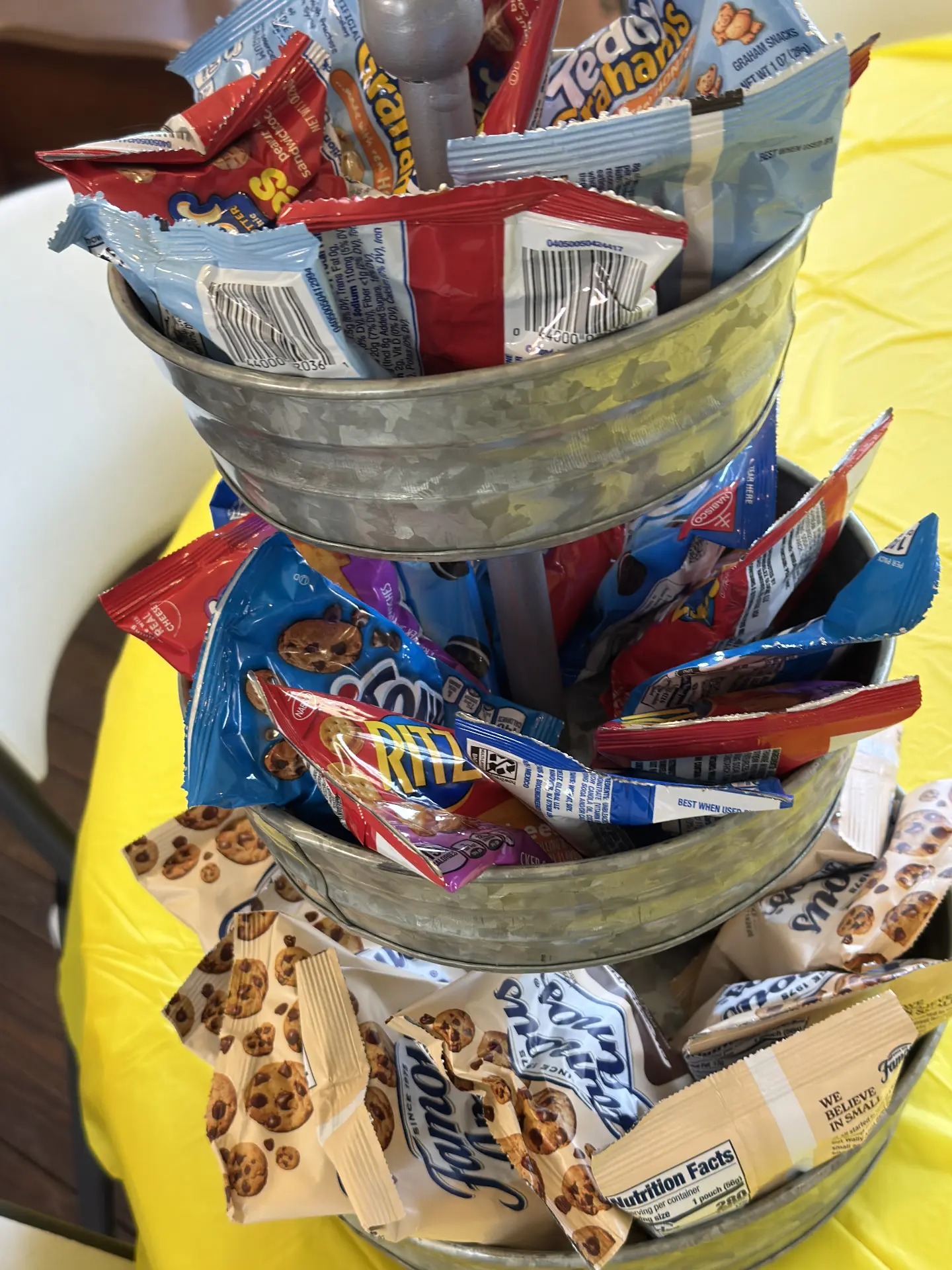 A tiered snack stand filled with cookie and cracker packs for STEM Day participants.
