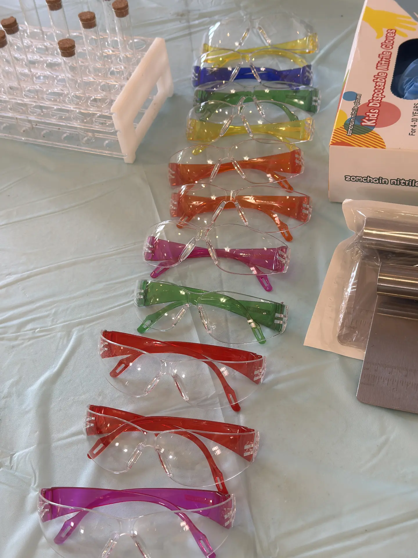 Rows of colorful safety goggles ready for students at STEM Day.
