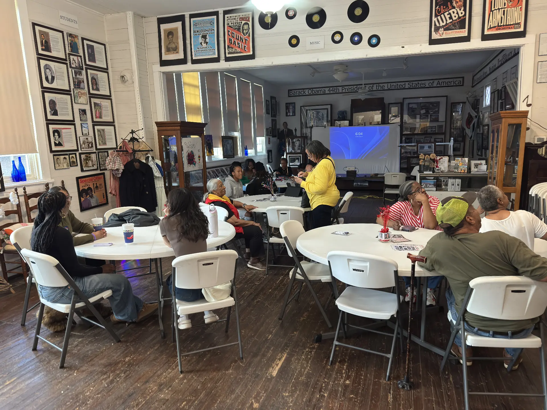 Guests play games around round tables in the museum's music room beneath vintage concert posters.