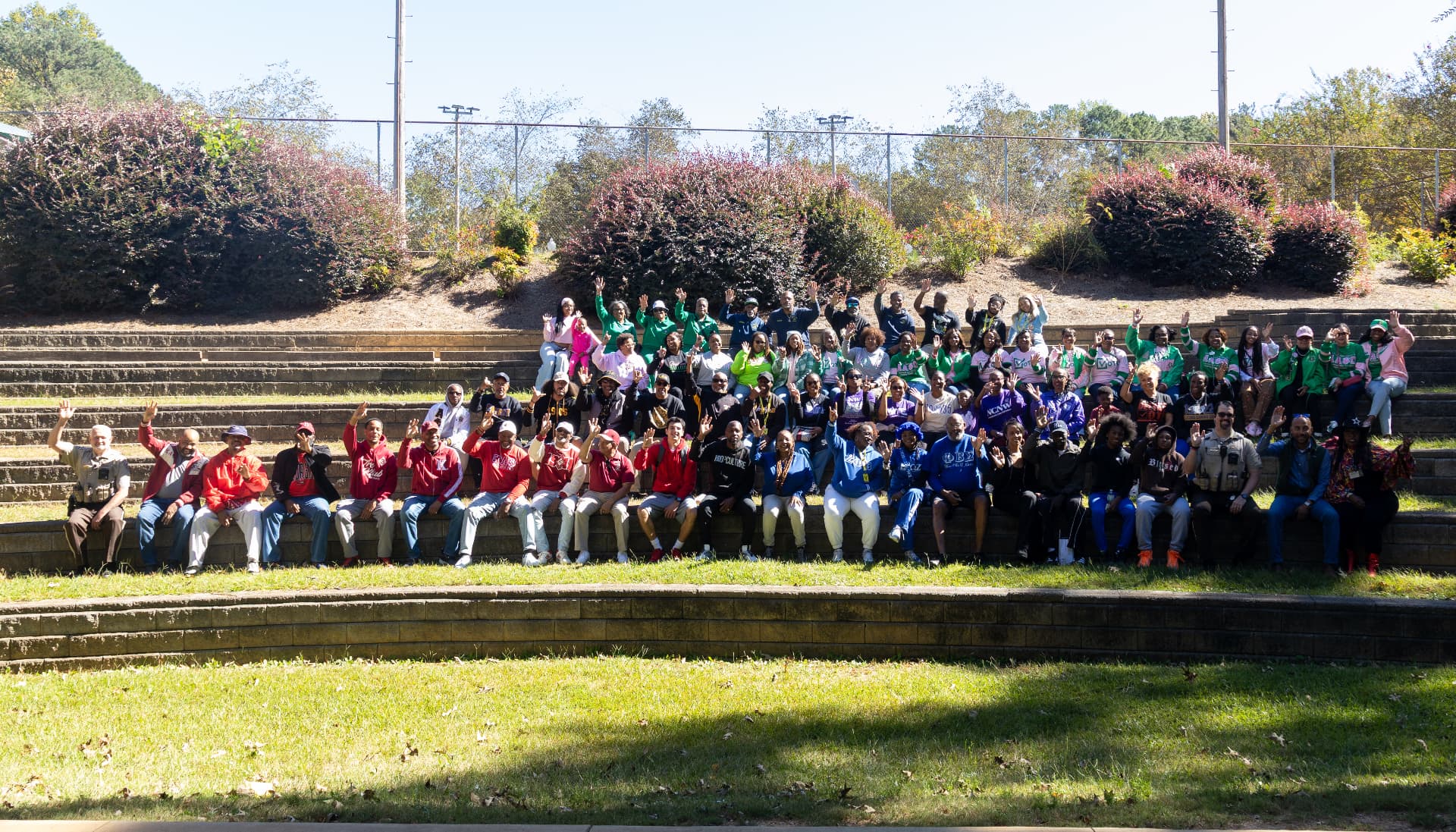 The full block party crowd — fraternities, sororities, deputies and neighbors — gathered on the amphitheater steps for a group photo.