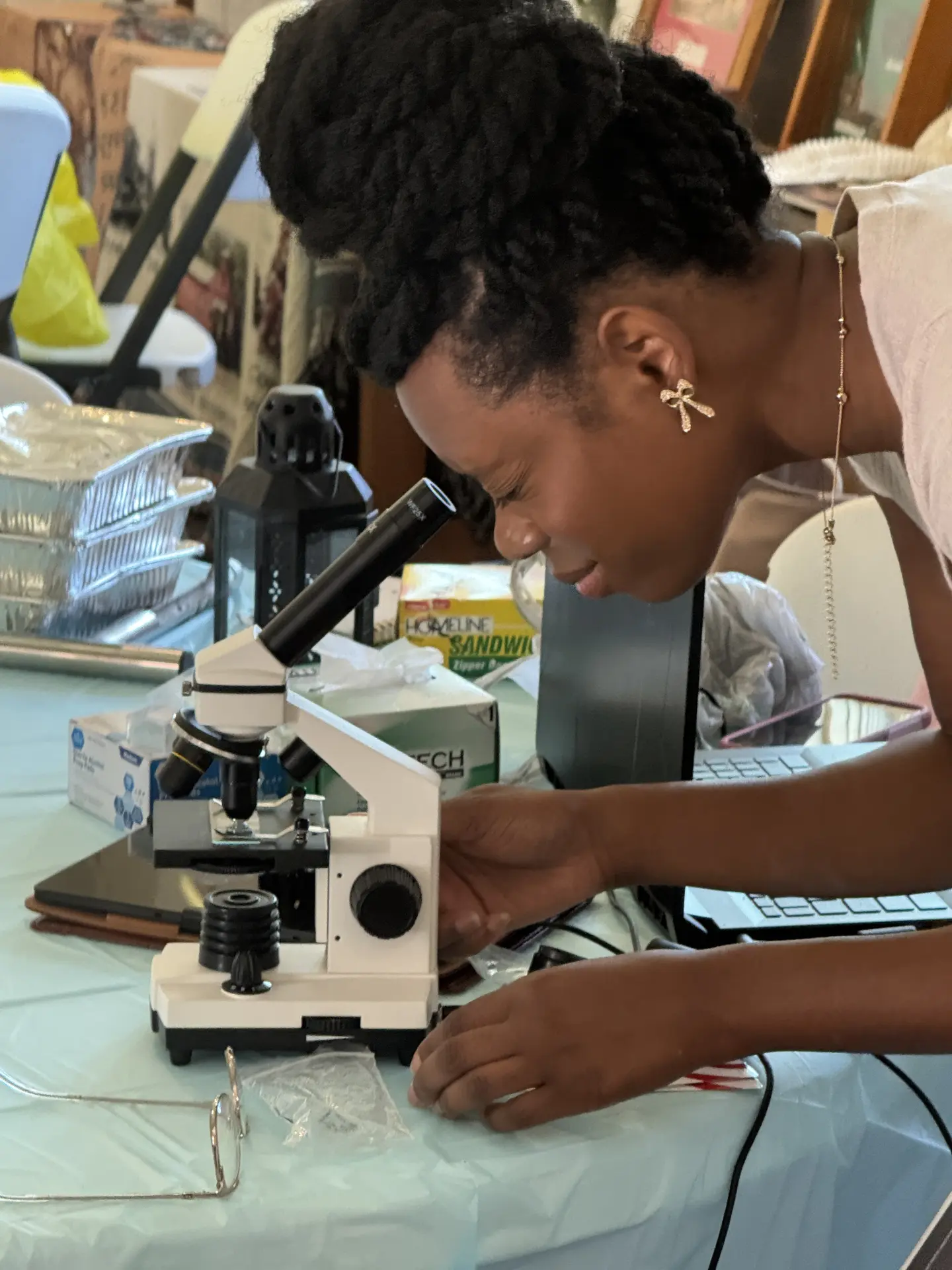 A student looks through a microscope during STEM Day activities in the museum.