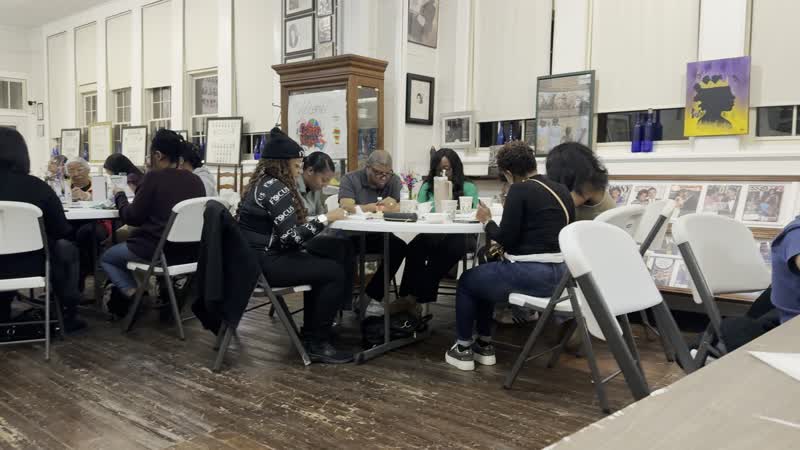 A slow pan across the room as guests play games and chat at their tables during Black History Game Night.