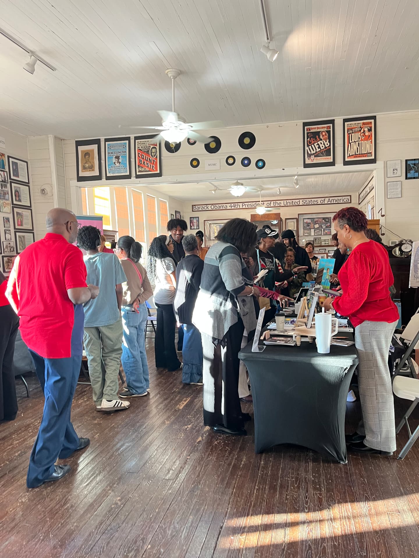 Visitors browse and shop at the author tables during the Authors Showcase inside the museum.